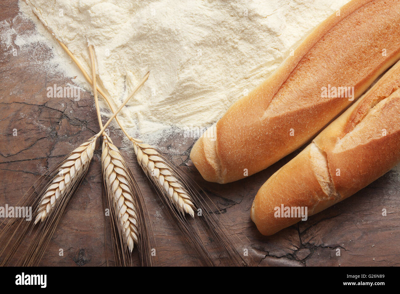Bread, flour and wheat on a wooden table Stock Photo