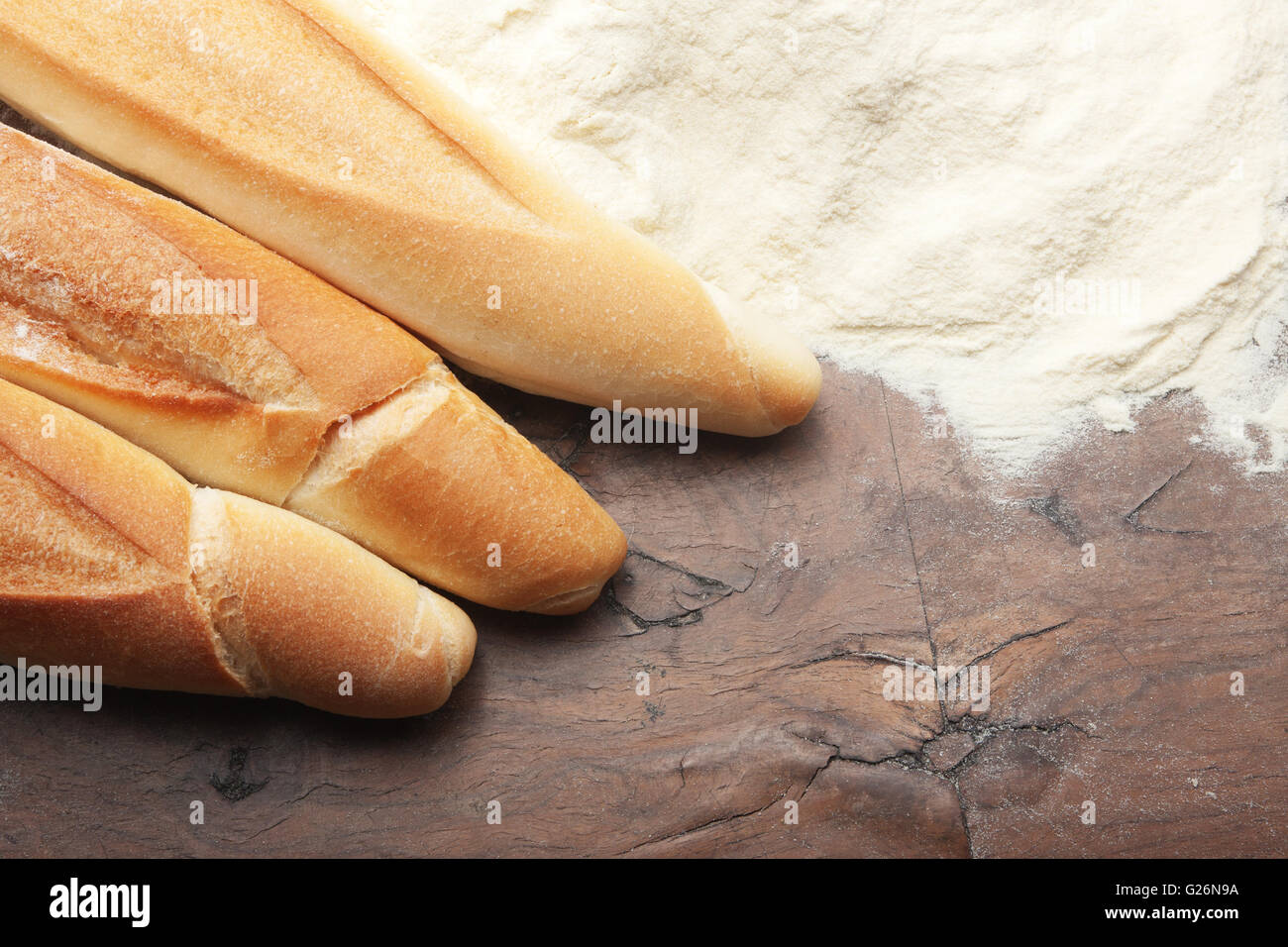 Bread and flour on a wooden table Stock Photo