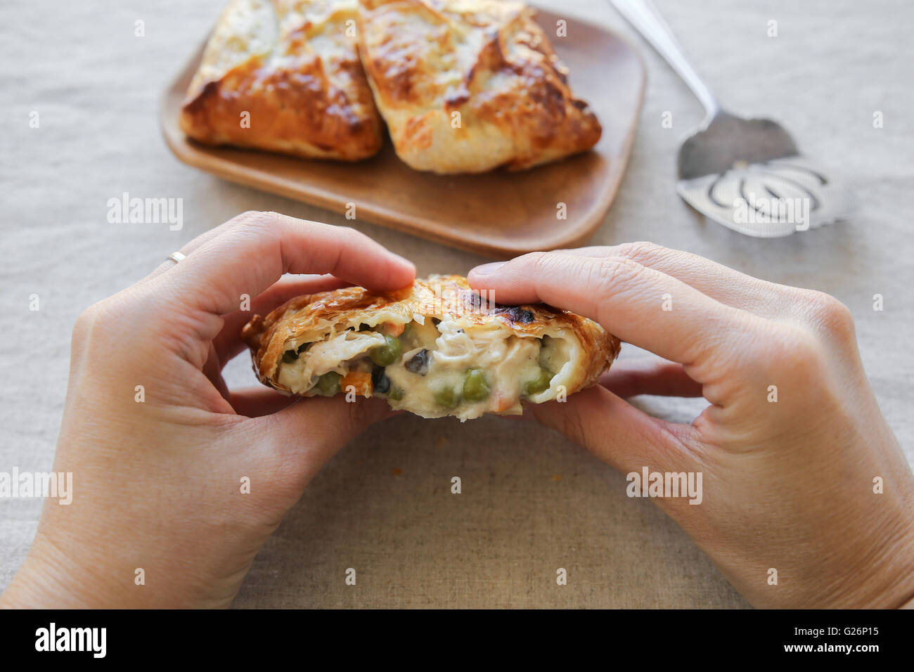 hands holding Homemade chicken puff pie, selective focus Stock Photo