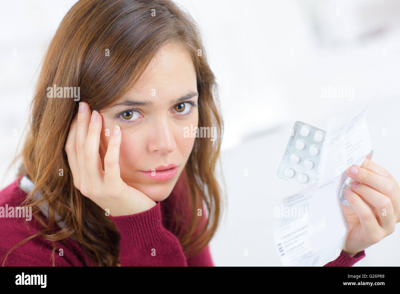 Worried woman holding tablets Stock Photo