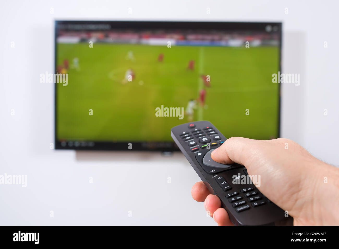 Watching soccer game on TV Stock Photo