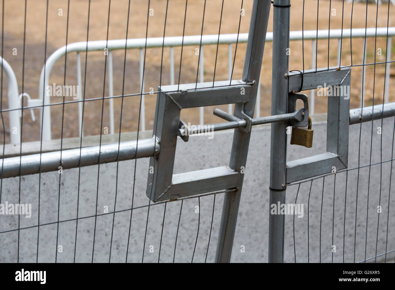 Entrance gate to a building site locked and chained shut. Stock Photo