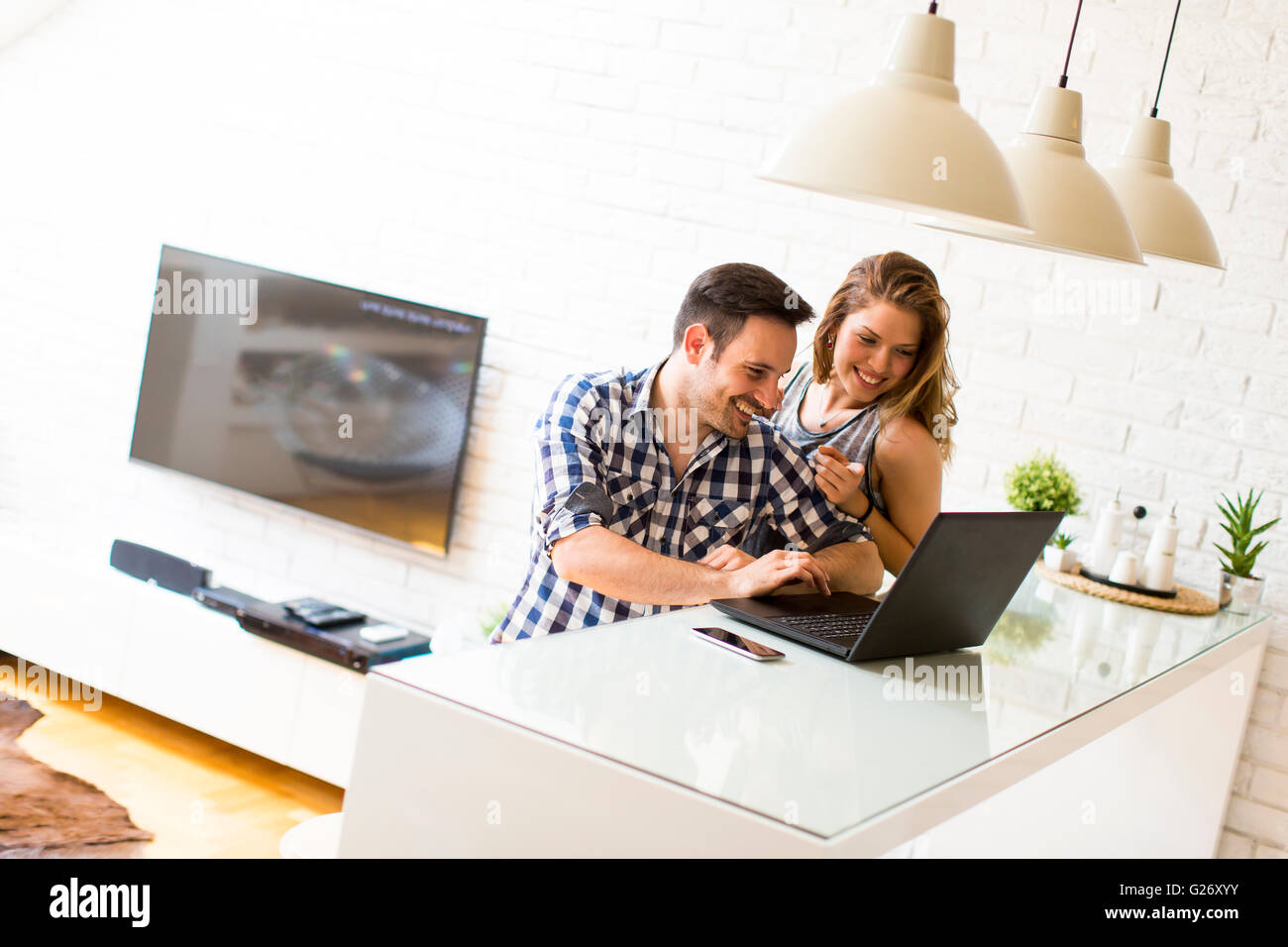 Young couple home laptop hi-res stock photography and images - Alamy