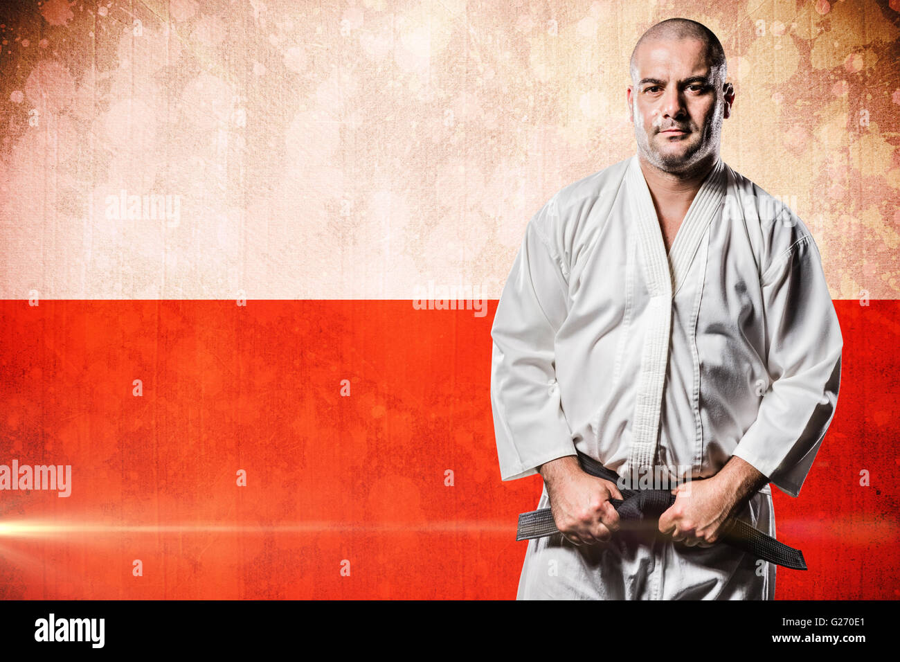 Composite image of fighter tightening karate belt Stock Photo Alamy