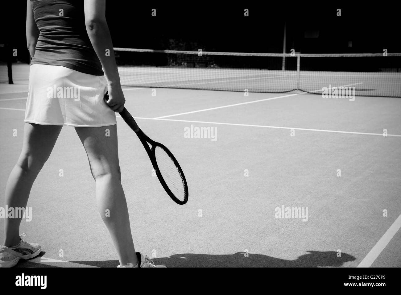 Tennis player standing on court Stock Photo