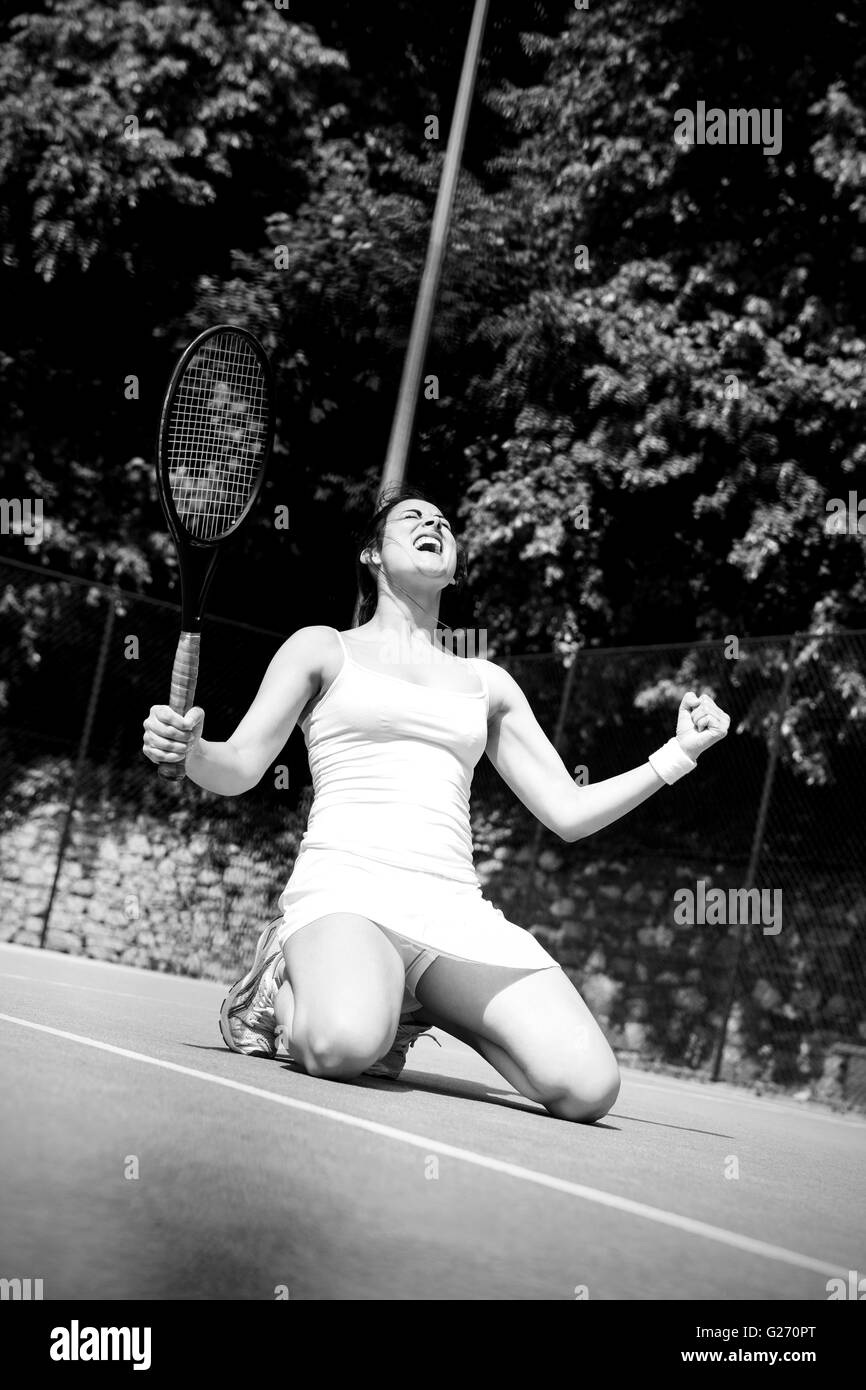Pretty tennis player celebrating a win Stock Photo