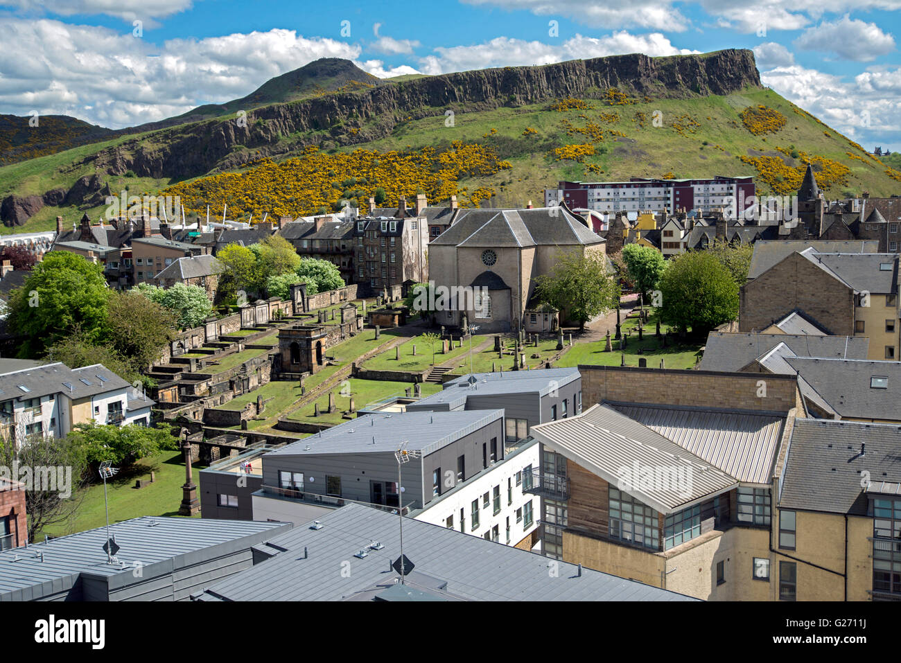 View looking over the 17th century Canongate Kirk towards Salisbury Crags and Arthur's Seat in Edinburgh. Stock Photo