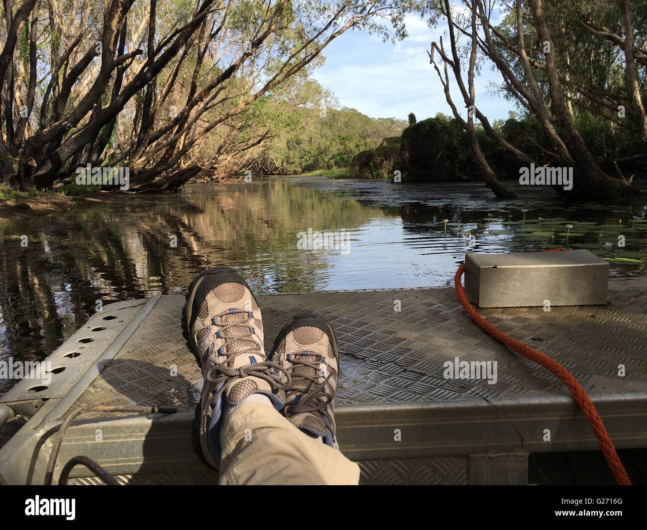 View of women's hiking boots in an aluminum flat-bottomed punt boat in Arnhem Land, Northern Territory, Australia. Stock Photo