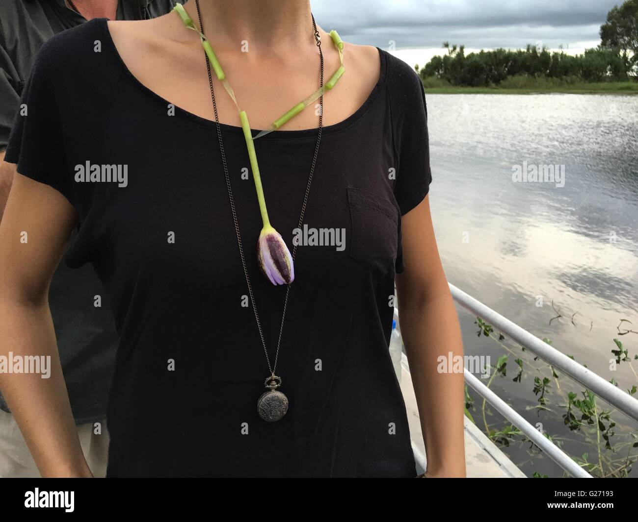 Woman wearing a necklace made out of a water lily on an aluminum punt boat in Arnhem Land, Northern Territory, Australia Stock Photo