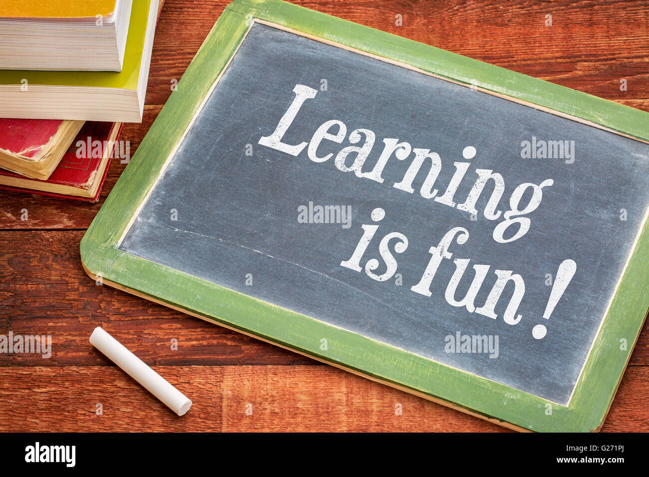 Learning is fun - inspirational text on a slate blackboard with a white ...