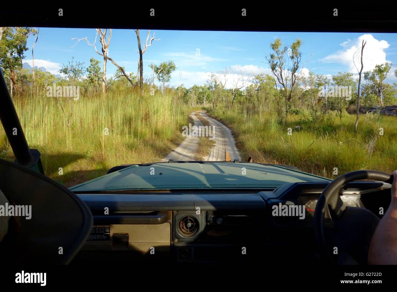 Driving in an old Land Cruiser safari four wheel drive (4X4) vehicle from the back seat passenger point of view in Arnhemland Stock Photo