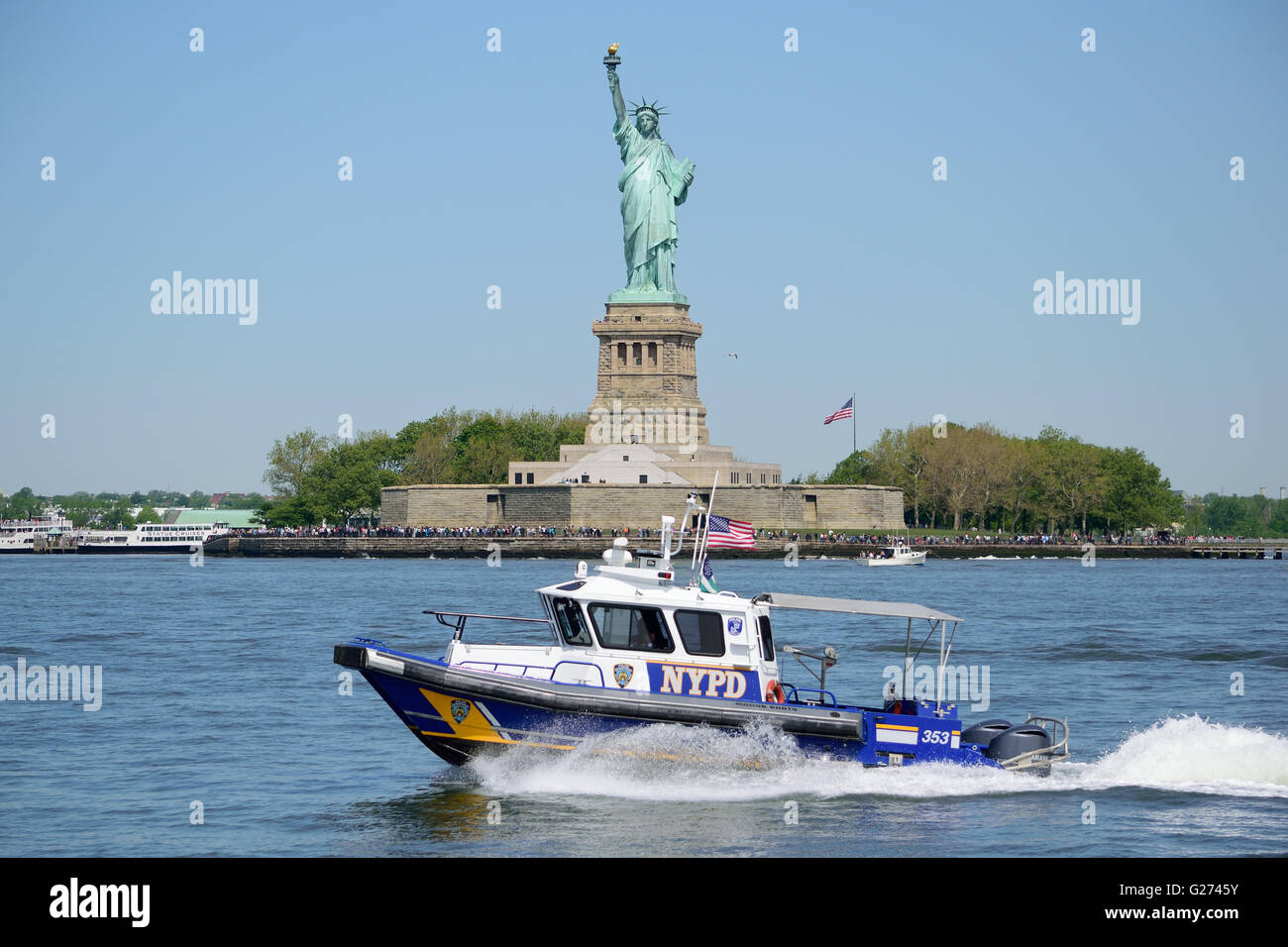 NYPD police boat on patrol in front the Statue of Liberty in New York