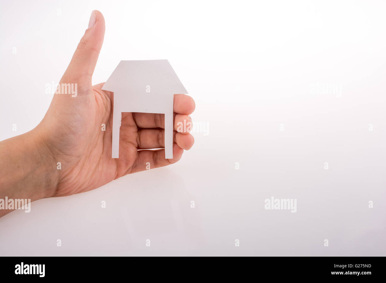 Hand holding a paper house on a white background Stock Photo - Alamy