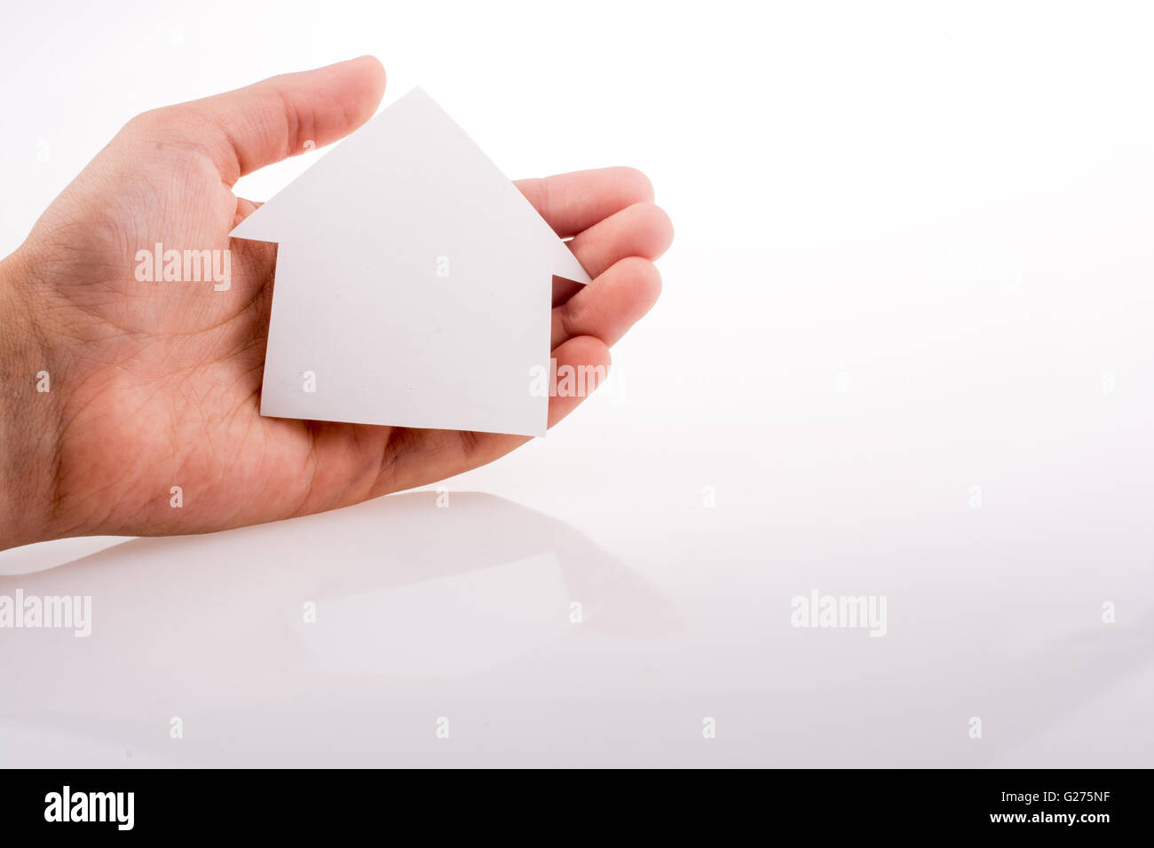 Hand holding a paper house on a white background Stock Photo - Alamy