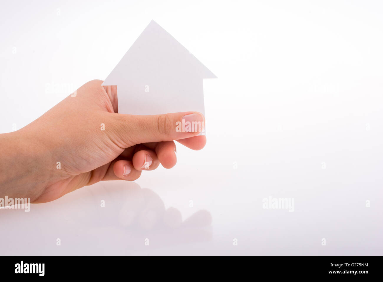 Hand holding a paper house on a white background Stock Photo - Alamy
