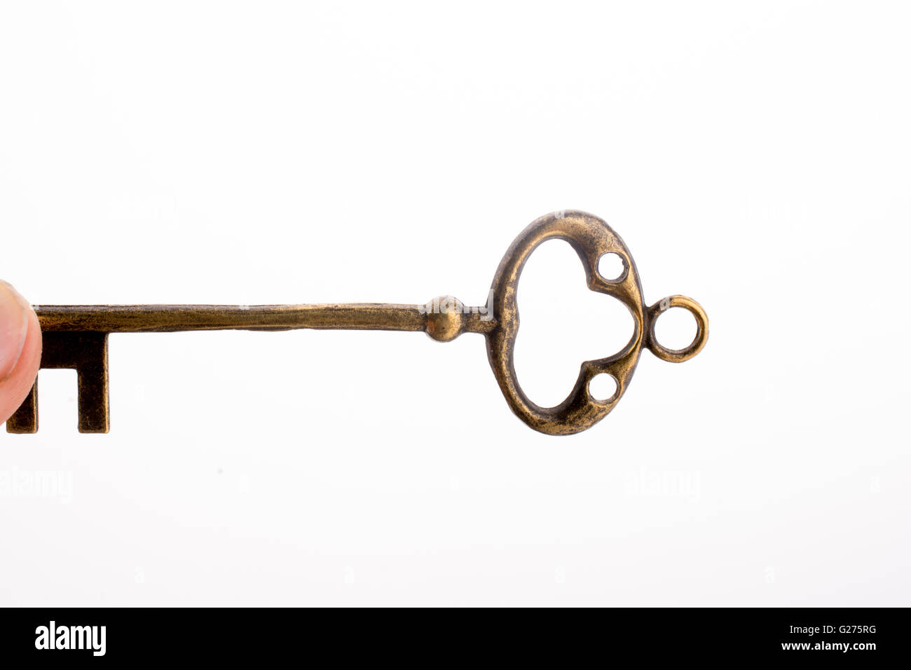 Hand holding a key on a white background Stock Photo - Alamy