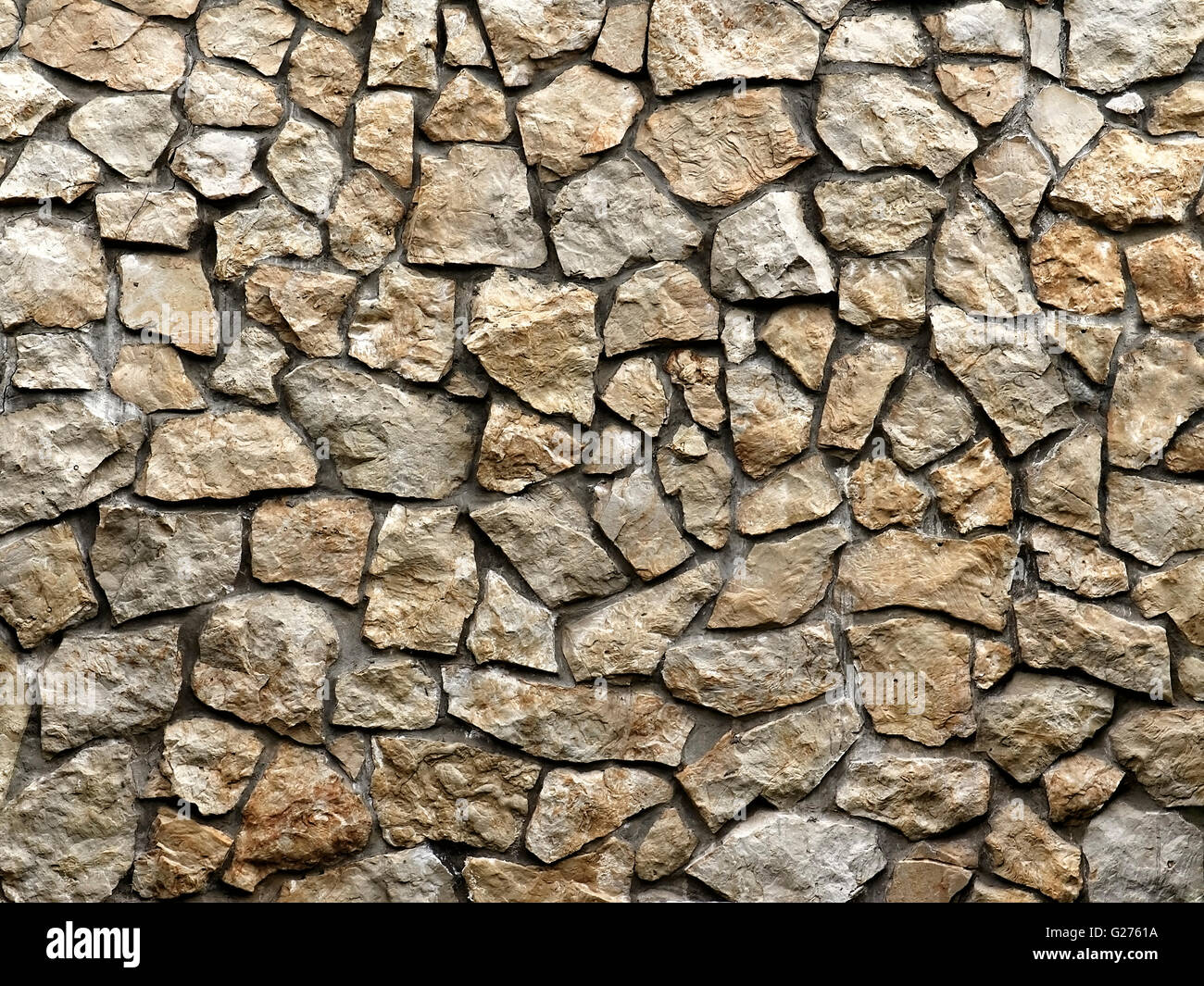 old grunge wall of rough stones as background Stock Photo