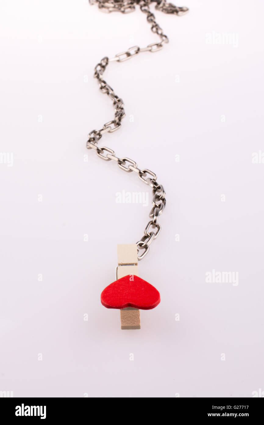 Hearted clip tied to a metallic chain Stock Photo