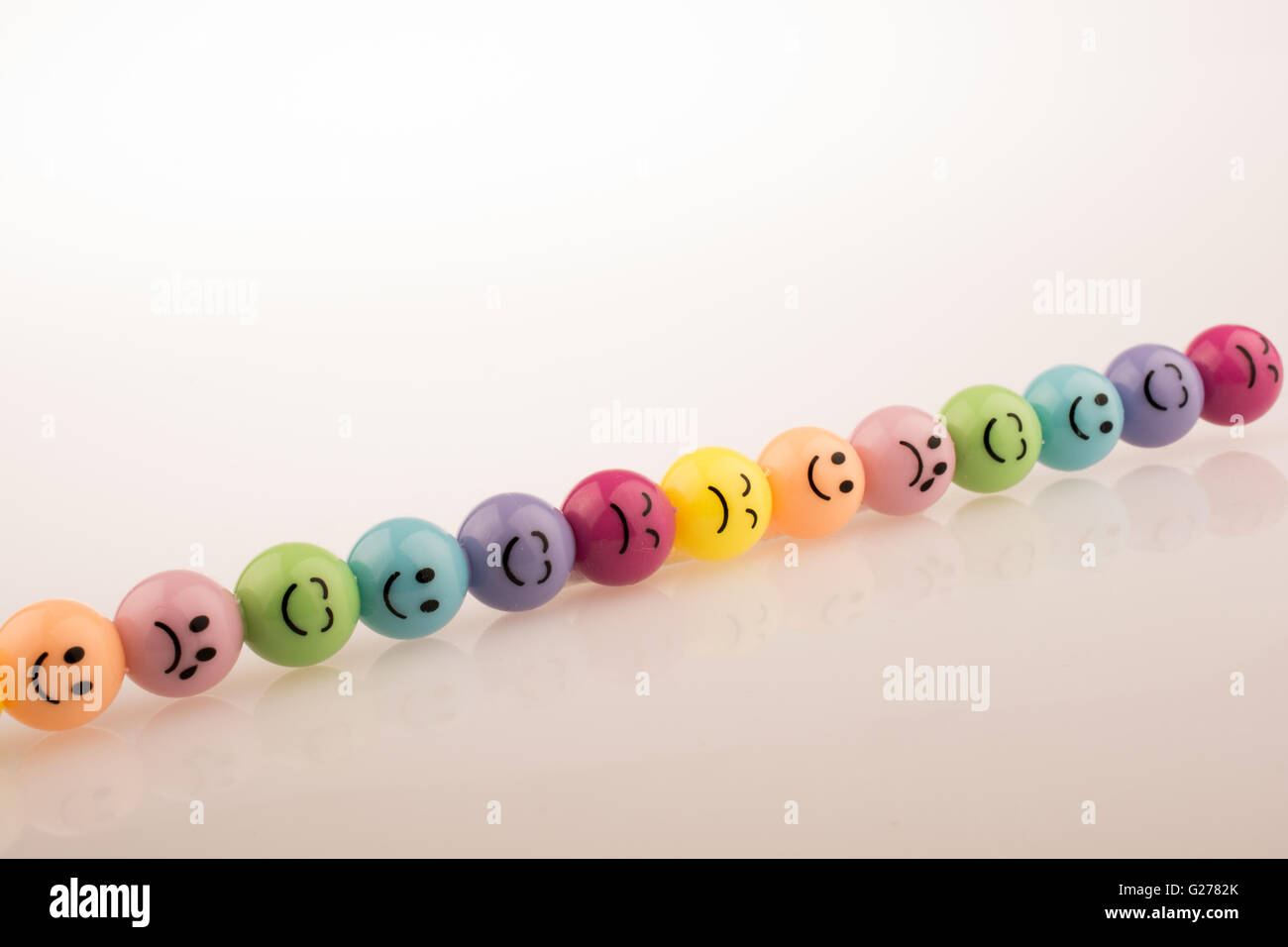 Color beads with facial expression on white background Stock Photo