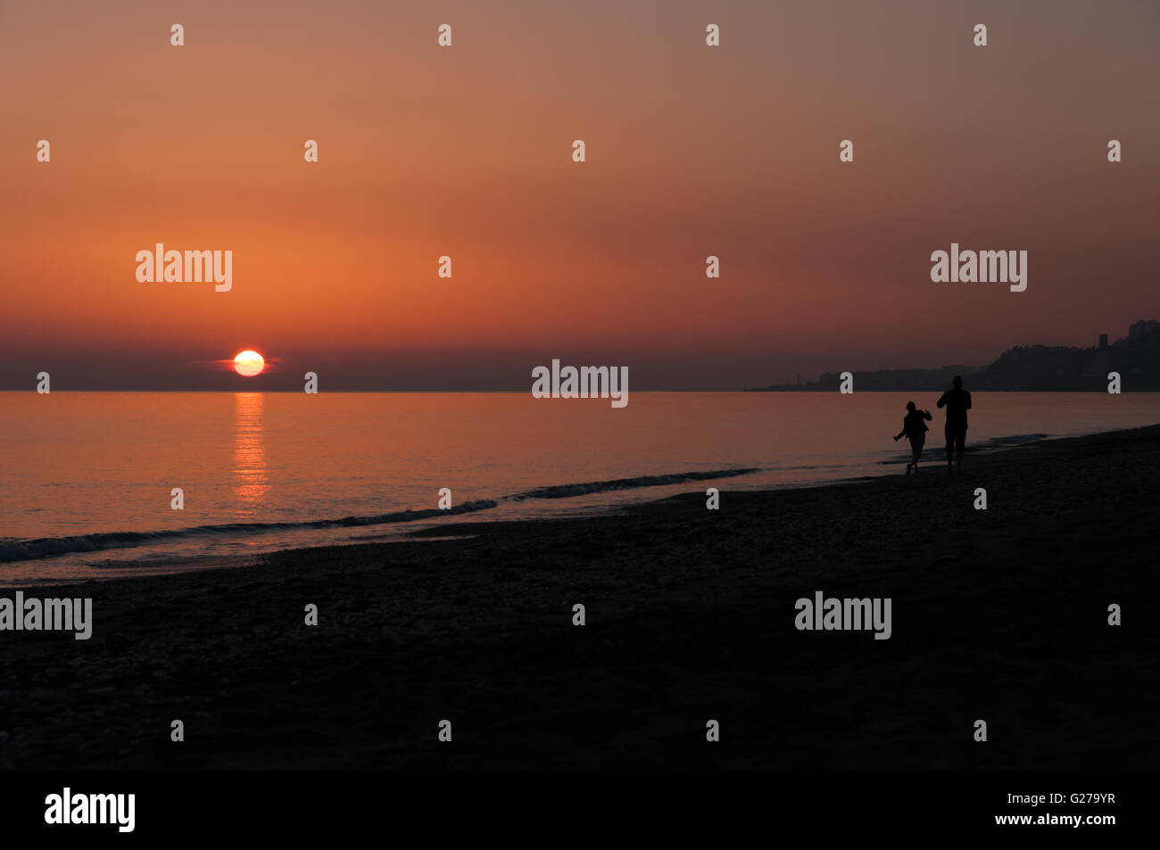 Silhouette Couple Beach Sunset Stock Photo - Alamy