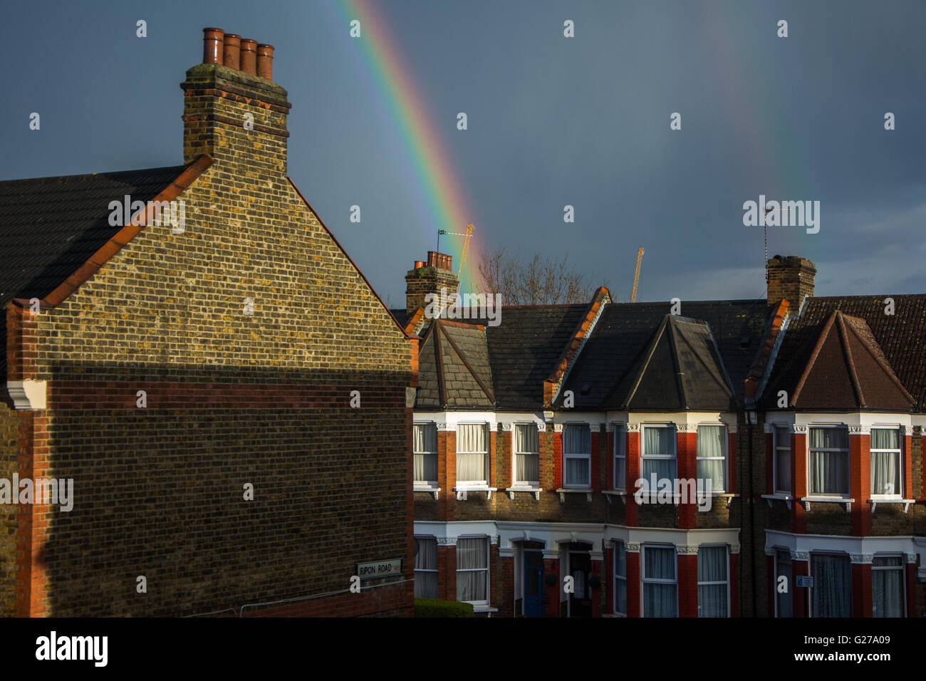 Rainbow on Victorian terraced houses in Tottenham, North London, UK Stock Photo