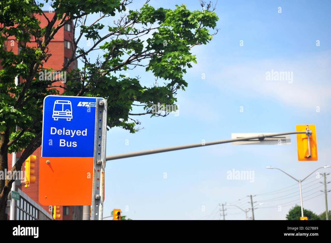 A bus sign with Delayed Bus written on it in London, Ontario in Canada ...