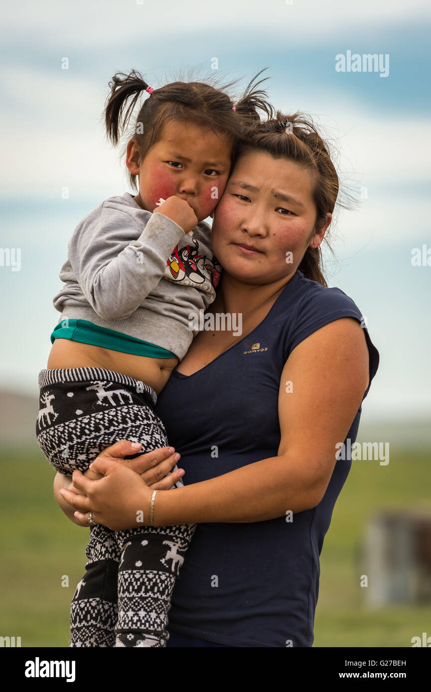Mongolian women holding her baby girl. Stock Photo
