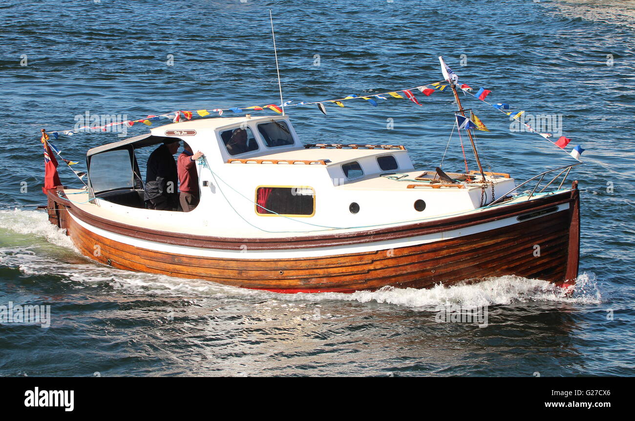 Betty Jean, a clinker-built cruiser, was part of the welcoming flotilla for the arrival of the TS Queen Mary back to the Clyde. Stock Photo