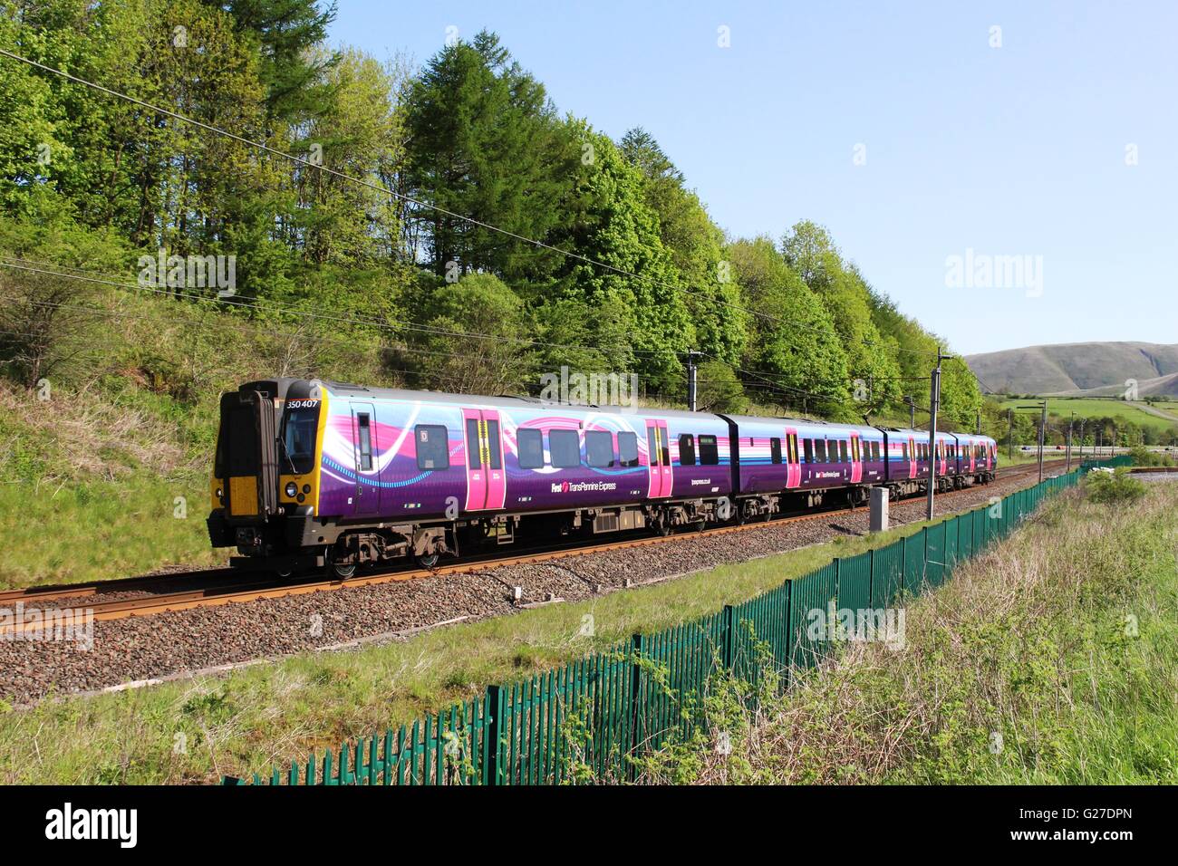 Class 350 Desiro electric multiple unit train in First TransPennine Express livery on West Coast Main Line near Beckfoot Cumbria Stock Photo