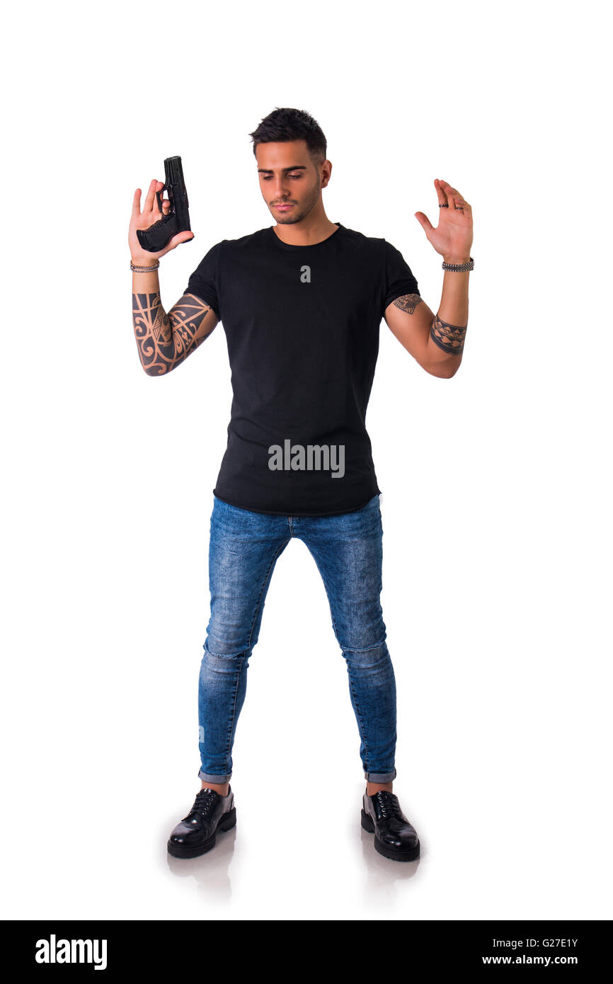 Portrait of detained tattooed man with gun. Studio shot. Isolated on white background. Full length body shot Stock Photo