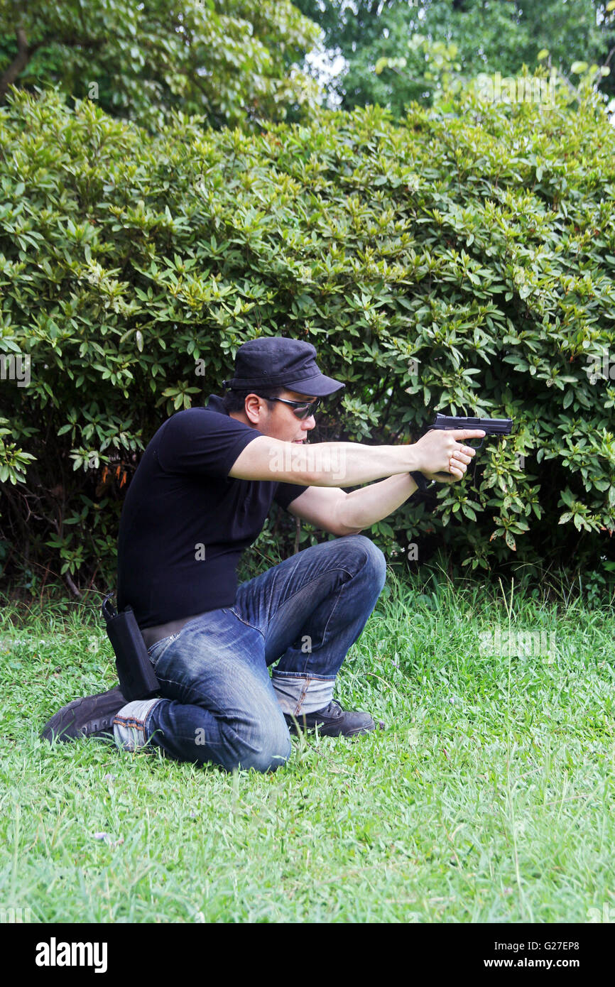 a man shooting a gun on cough ipsc ipda Stock Photo