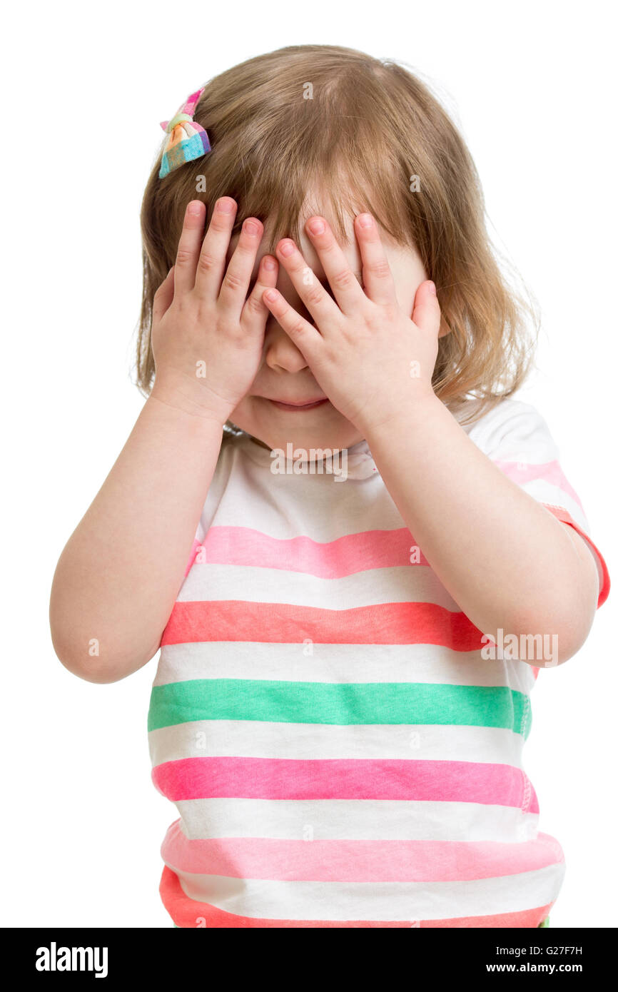 child hiding face by hands Stock Photo
