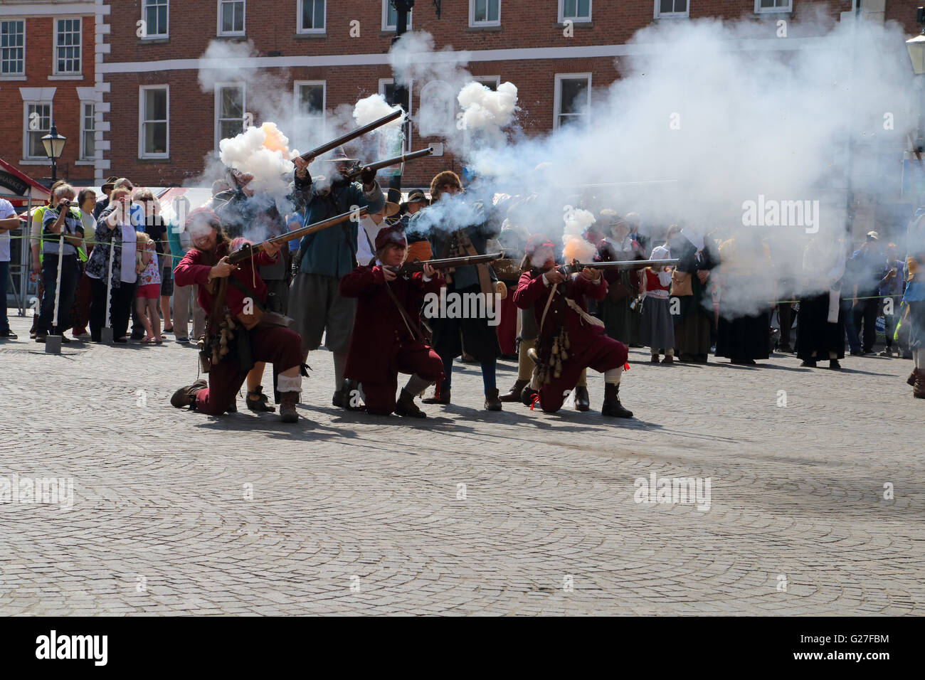 Members of the sealed knot historical reenactment society firing off matchlock rifles in the market place of Newark on Trent Stock Photo