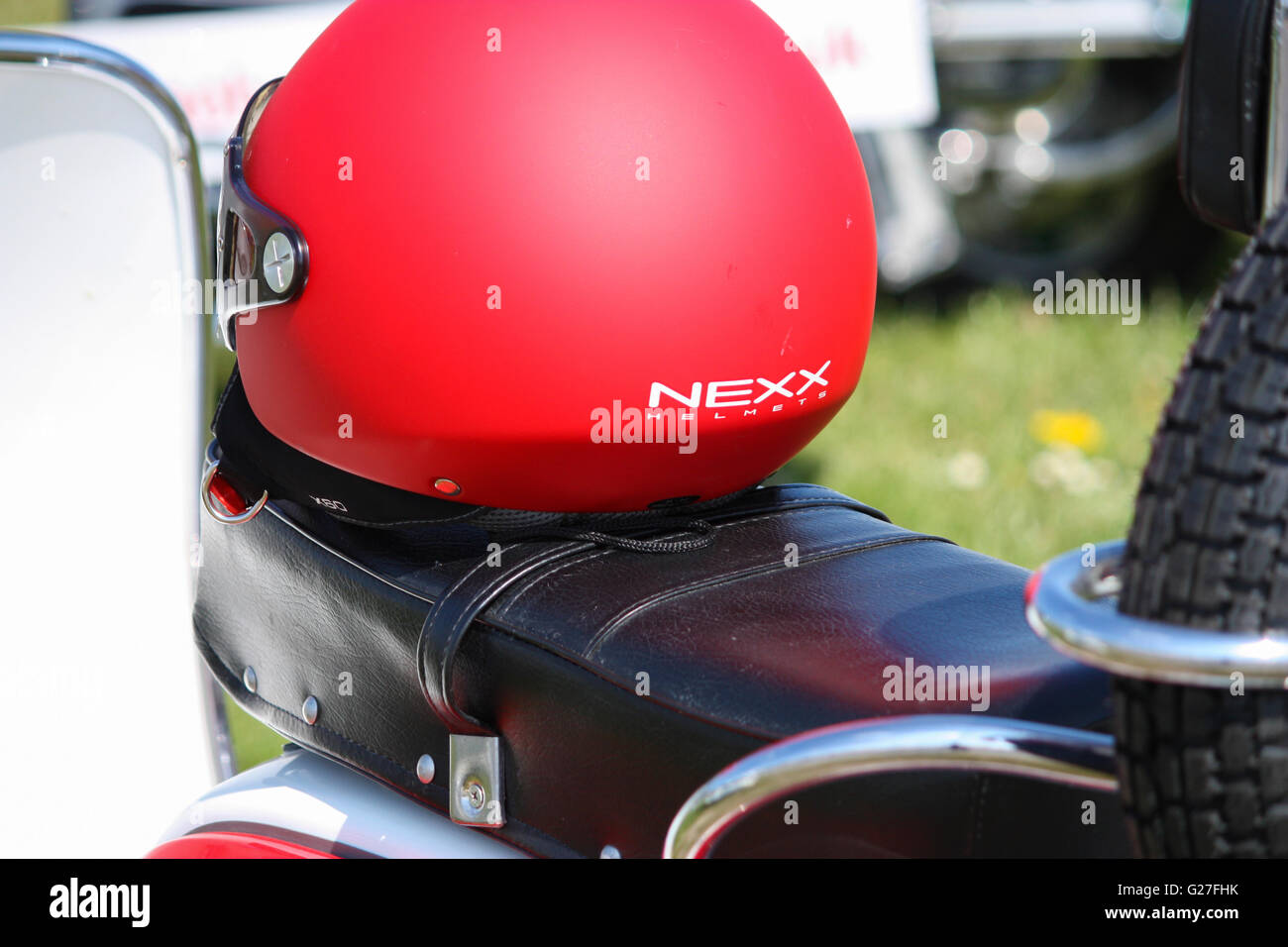 Red Nexx crash helmet on a Lambretta scooter saddle Stock Photo Alamy
