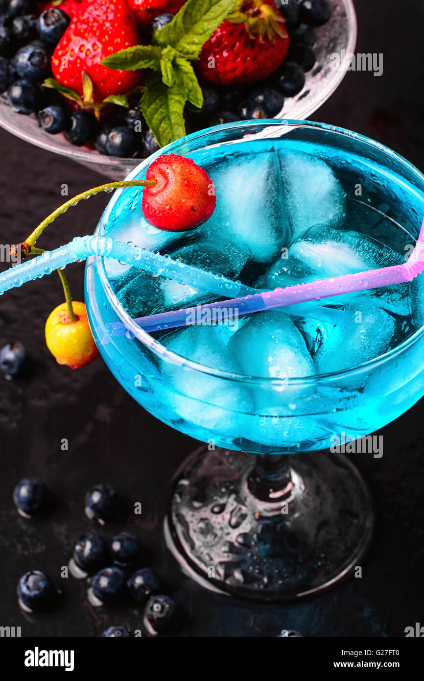 glass of blue alcohol cocktail in glass with cherry Stock Photo Alamy