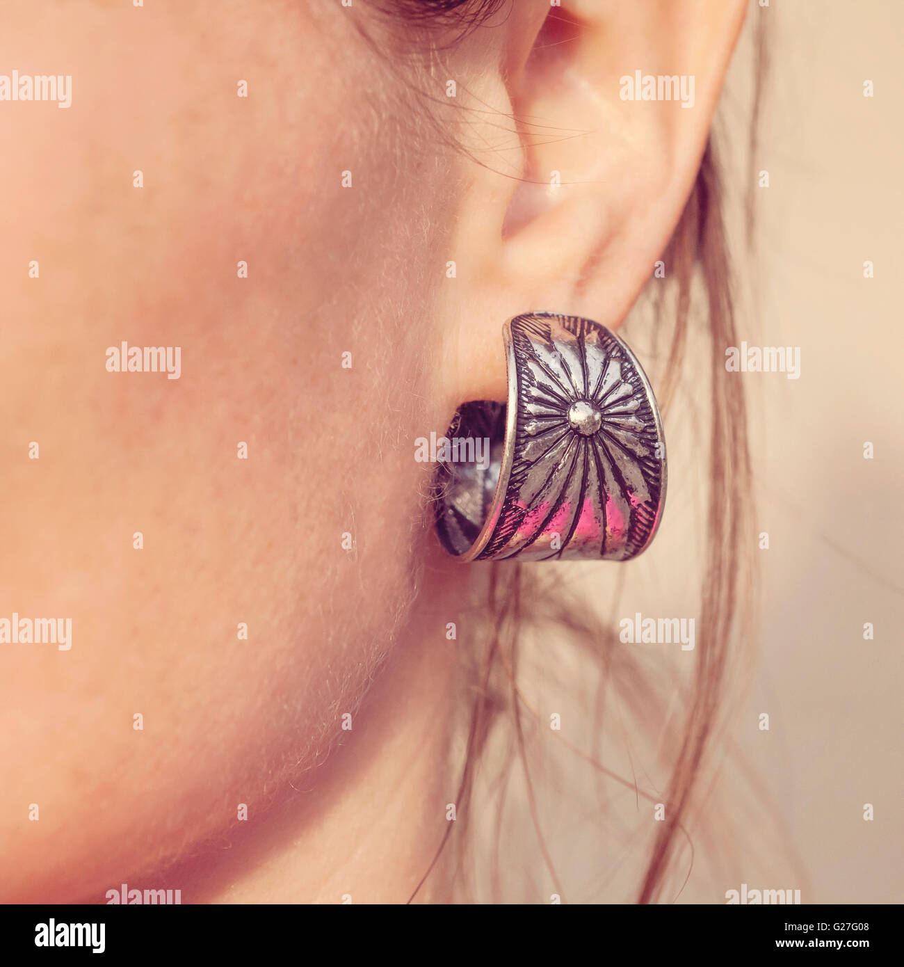 Elegant silver female earring Stock Photo