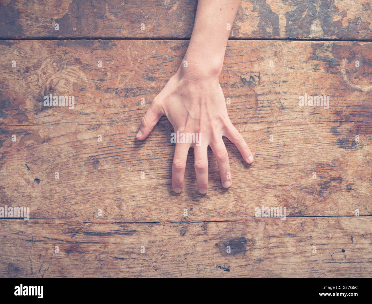 A young female hand is scratching a wooden table Stock Photo Alamy