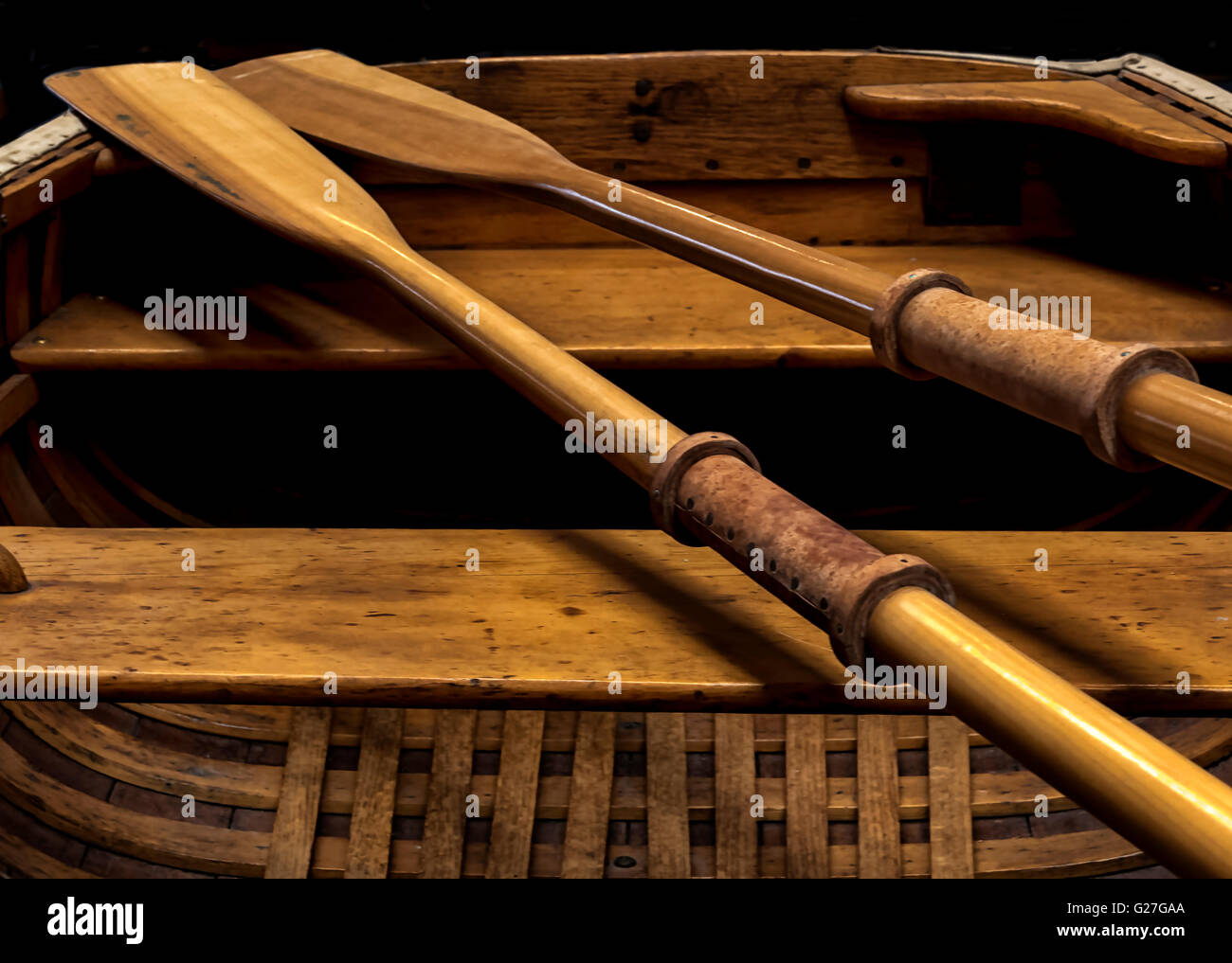 An editorialized view of oars and the cockpit of a 1900's row boat.Useful as a designers background  image or as wall art Stock Photo
