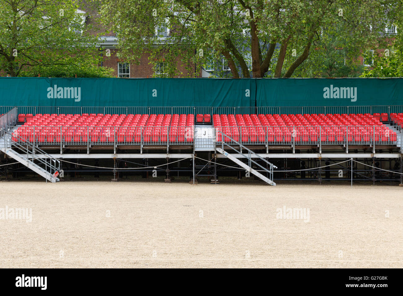 Temporary raked red spectator seating for an outdoor event Stock Photo