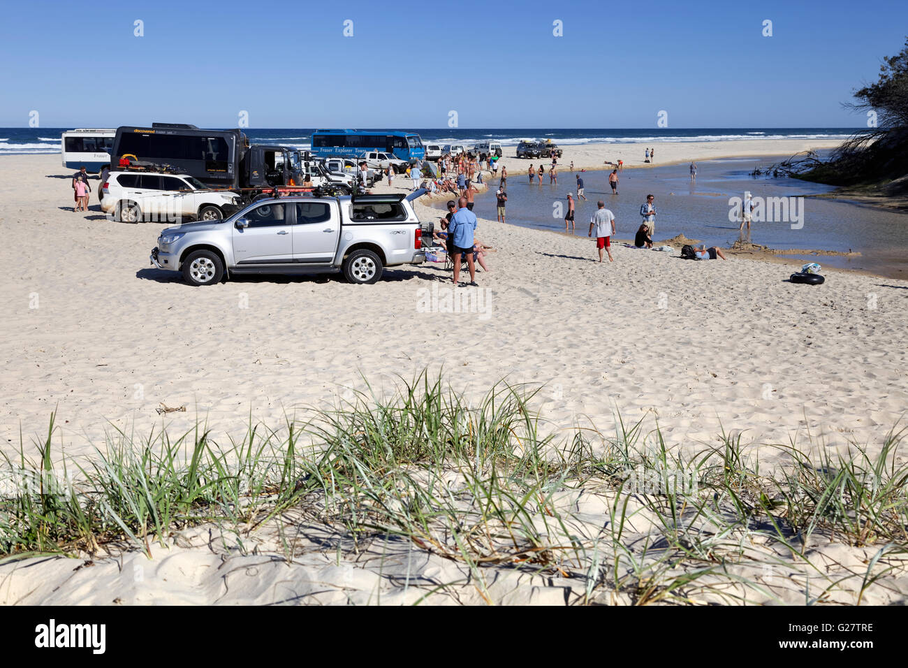 Cars and people on excursion destination Eli Creek, on 75 Mile Beach Road, official Highway, UNESCO World Heritage Site Stock Photo