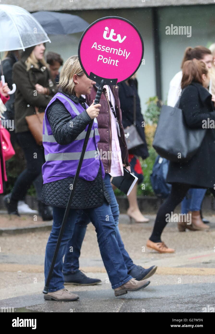 Staff leave the ITV studios following a fire drill on Monday afternoon (11Apr16). 'Alarm