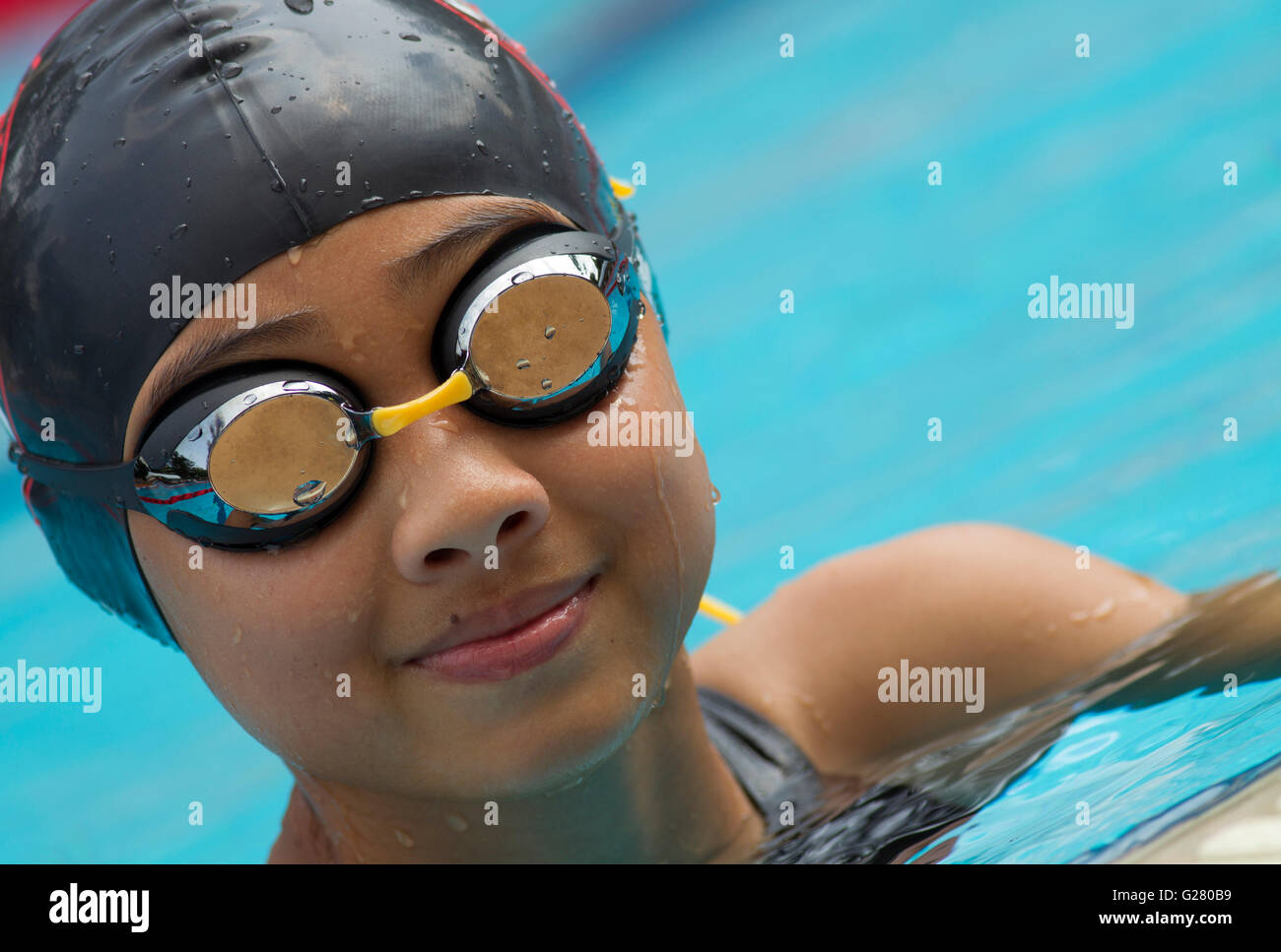 Girl wearing swimming cap goggles hi-res stock photography and ...