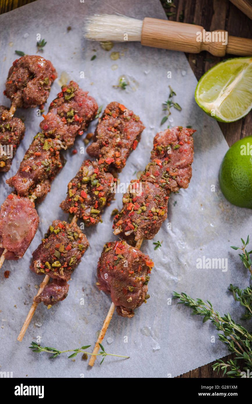 beef skewers marinated ready for bbq, fresh herbs, spices and lime