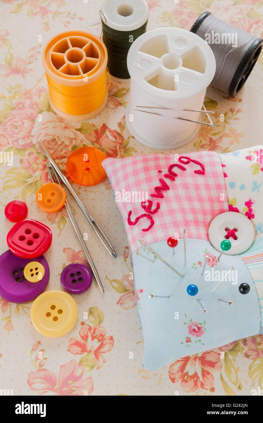 Sewing needles threads and buttons with a pin cushion Stock Photo Alamy