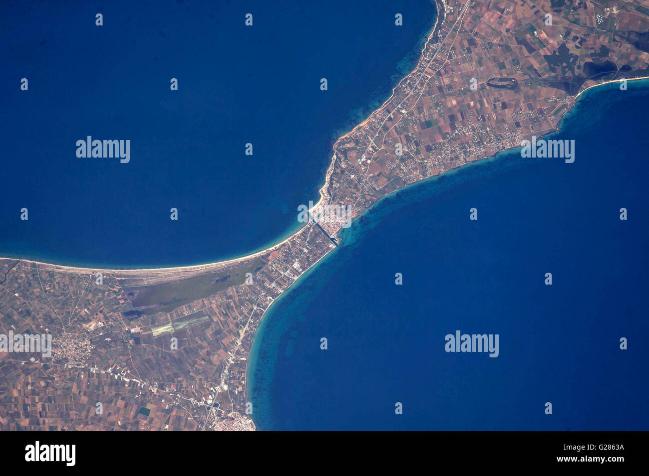 View from the International Space Station of the ancient Potidea canal in Greece May 13, 2016. For 2,000 years this canal has connected the Thermaikos and Toronaios Gulfs. Coastal currents and erosion over 2,000 years appear to have displaced the two sides of this isthmus seen in the coastline's misalignment. Stock Photo