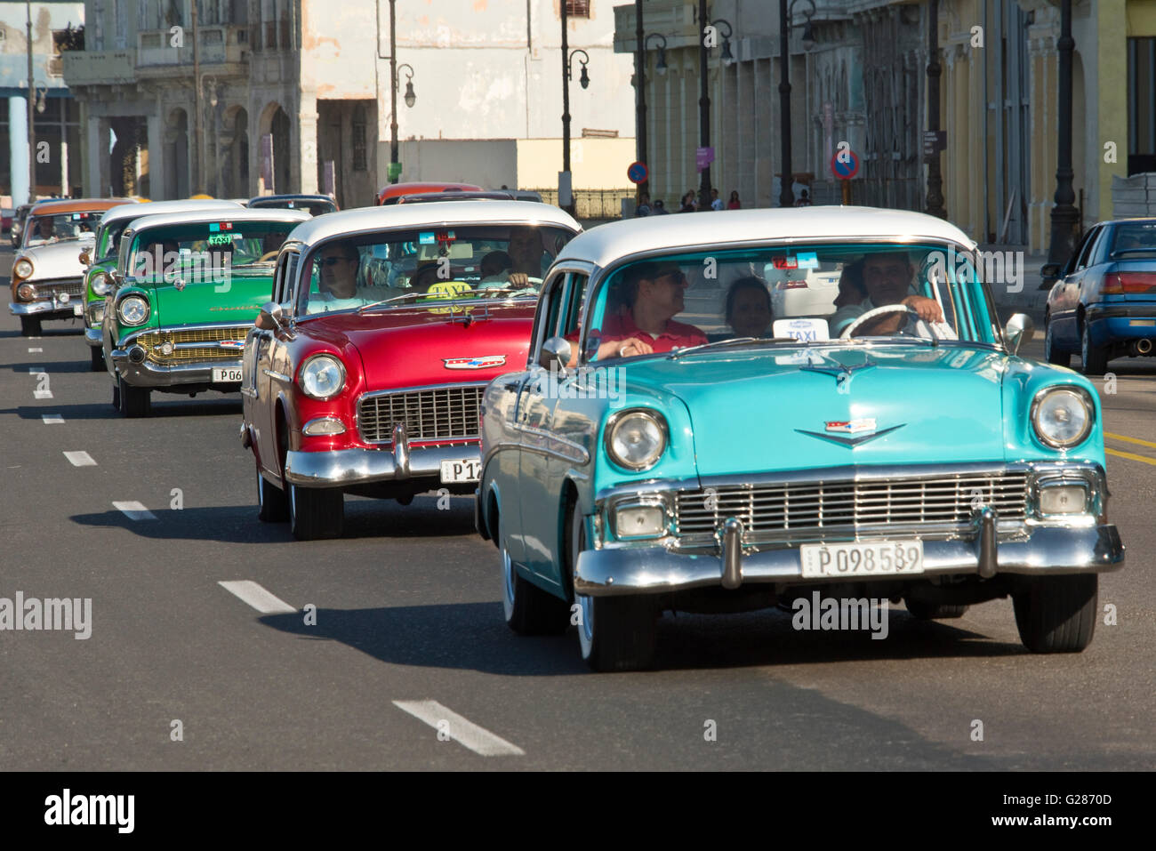 A compressed perspective view of American cars along the Malecón in Havana  with a 1956 Chevrolet Bel Air in the foreground. Stock Photo