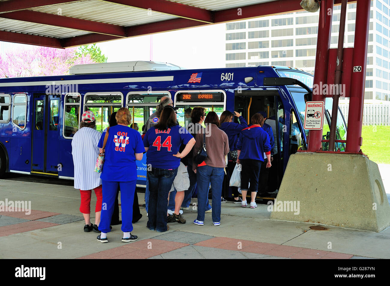 Baseball fans waiting to bard a bus that provides transportation to