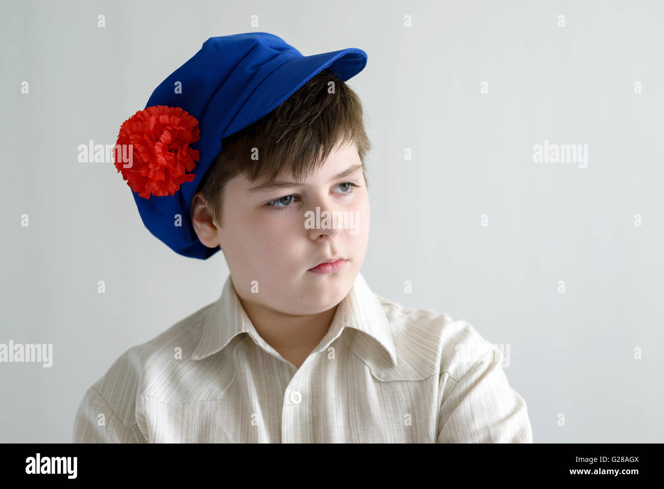 Portrait of aboy teenager in Russian national cap with cloves Stock