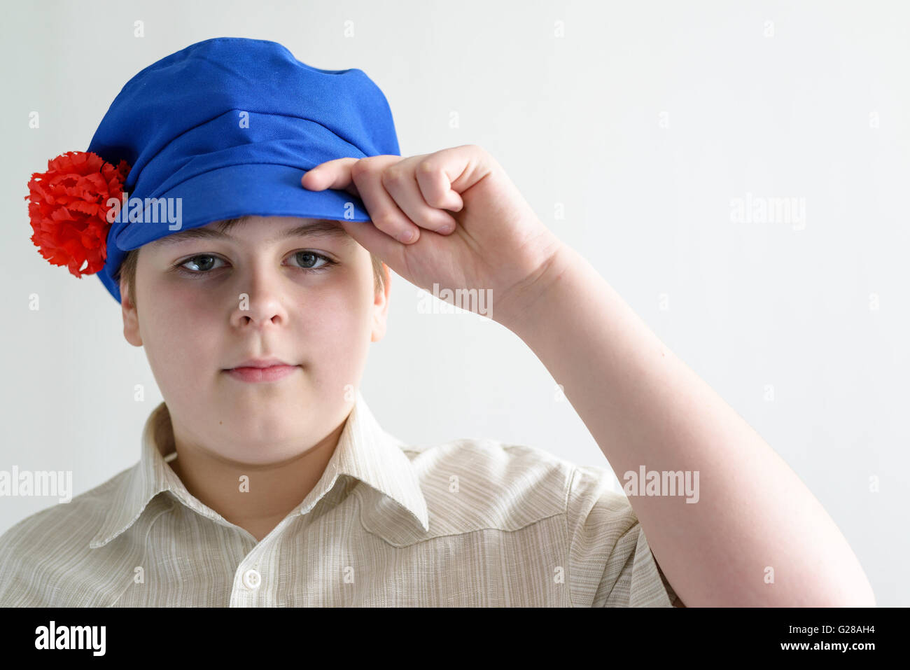 Portrait of boy teenager in Russian national cap with cloves Stock