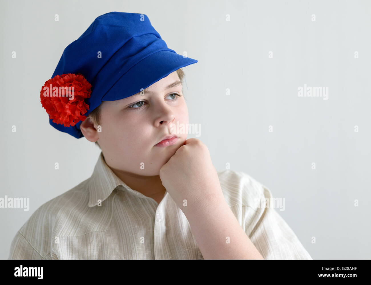 Portrait of aboy teenager in Russian national cap with cloves Stock
